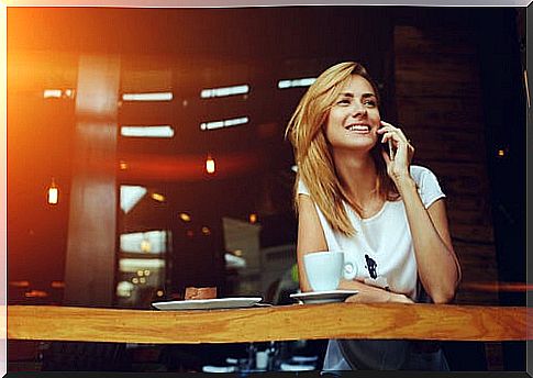 Woman smiling while having coffee