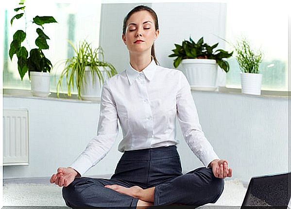 woman in lotus position practicing breathing techniques