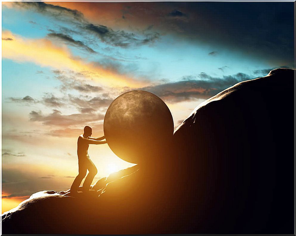 Man climbing rock up a mountain