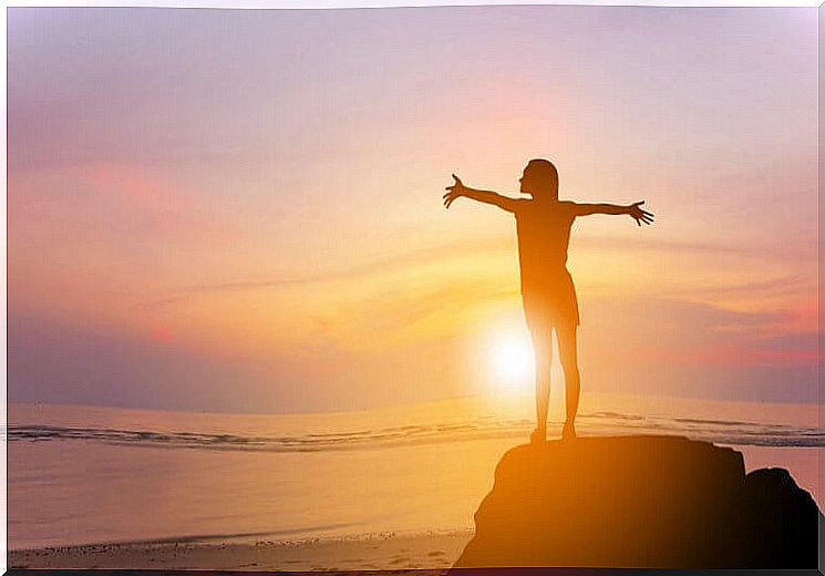 Happy woman watching the sunset