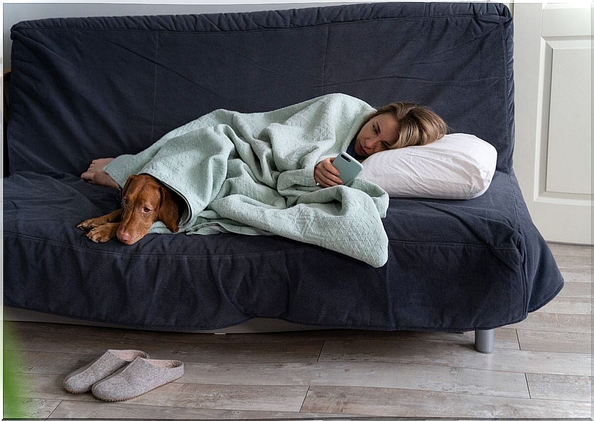 girl on the couch with dog to represent people avoid their emotions