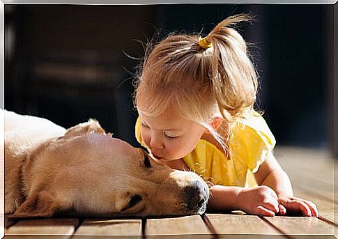 Girl blowing a kiss to a dog