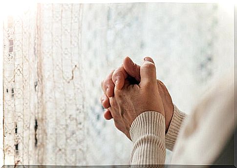 Hands of a senior person praying