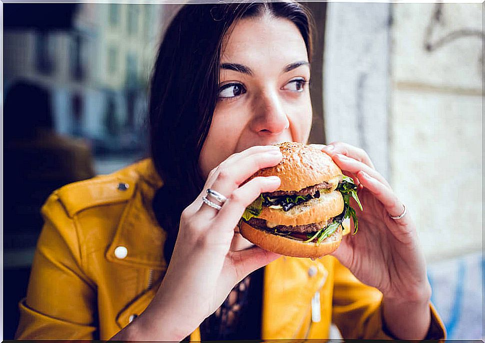 Woman eating a hamburger