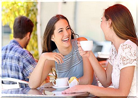 Girlfriends talking drinking coffee