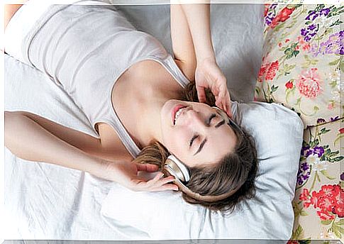 Girl listening to music in bed