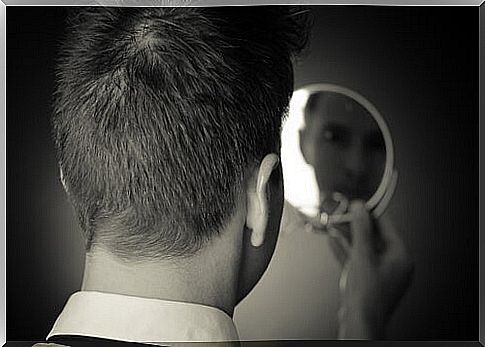 Man with fear looking in the mirror 