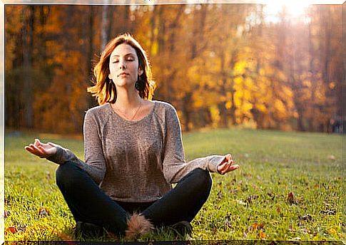 Woman doing meditation in the field