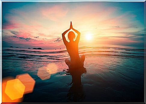 Woman doing yoga in the sea