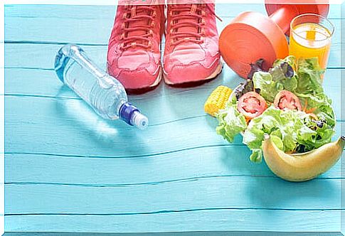 Healthy food with water and sneakers to represent healthy lifestyle habits