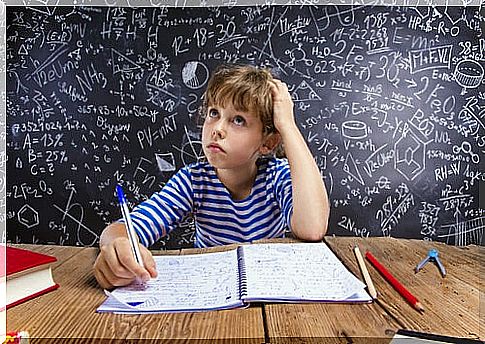 Boy thinking while doing homework