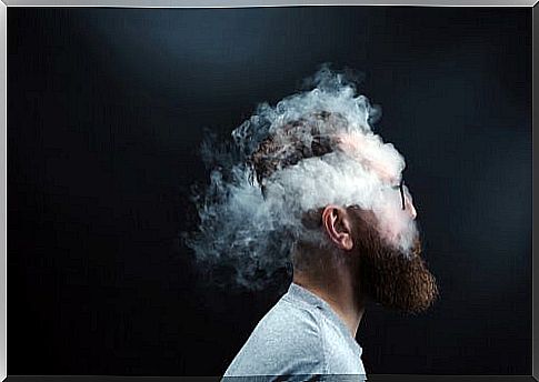 Man surrounded by smoke feeling the weight of an open wound