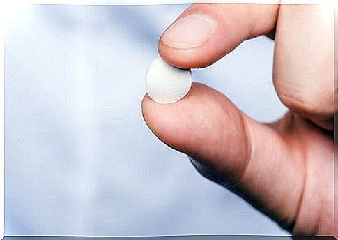 Hand with white pill