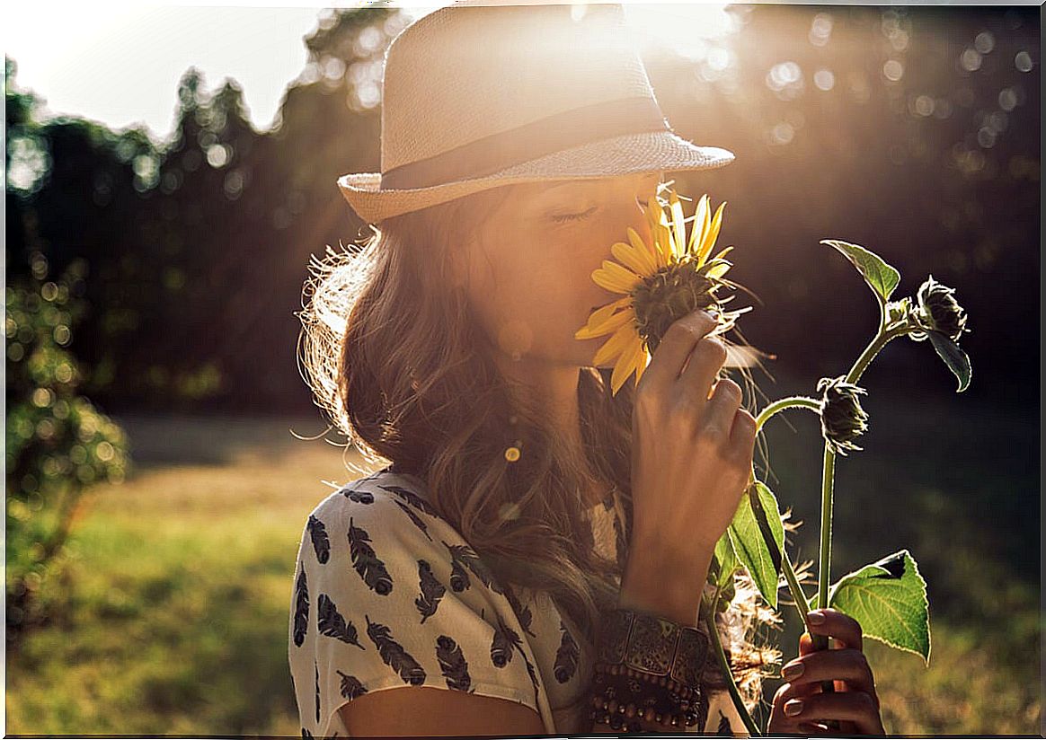 Woman smelling a sunflower