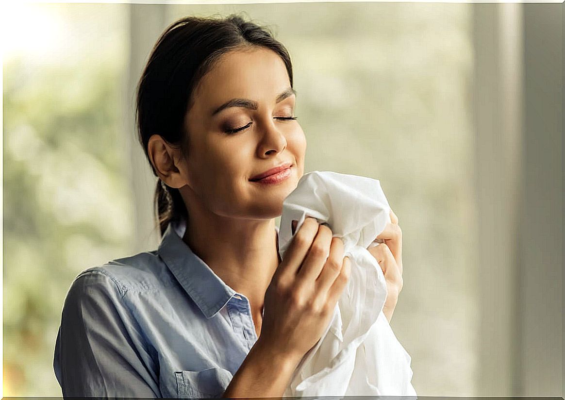 Woman smelling clothes